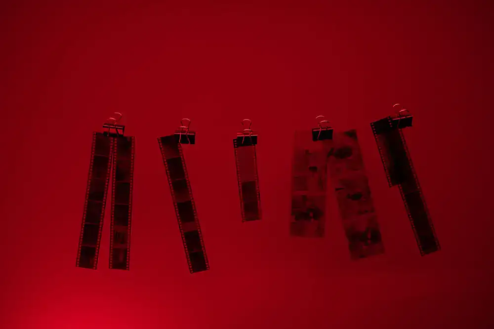 Film negatives hanging to dry in a professional darkroom