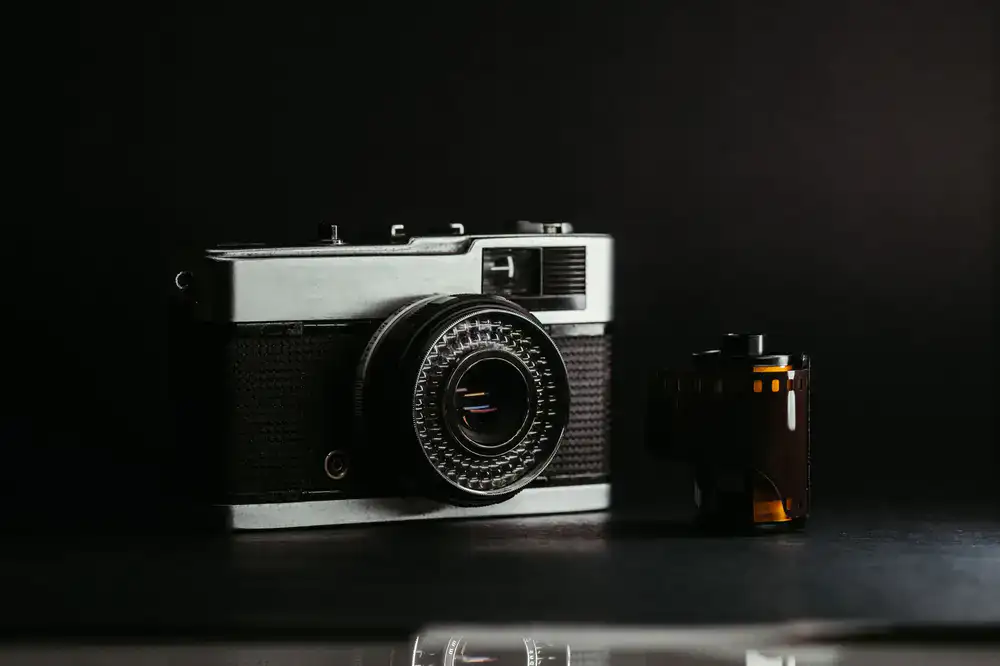 Close up of a vintage camera lens and loaded film roll