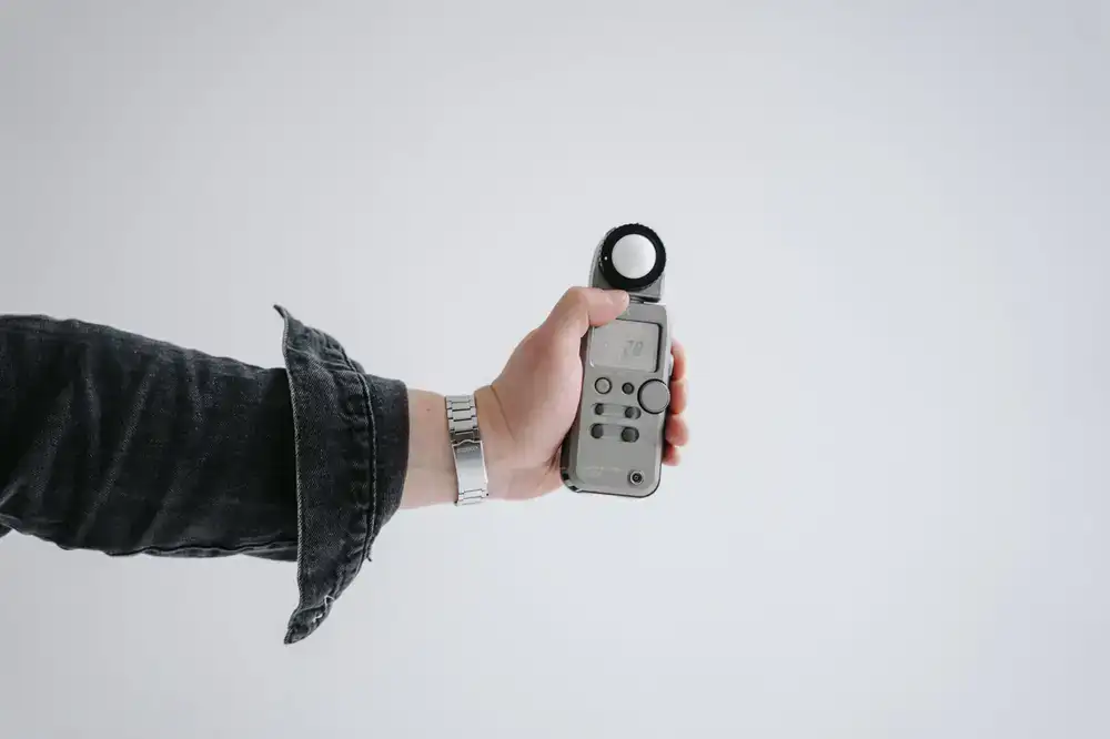 Handheld light meter taking a reading
